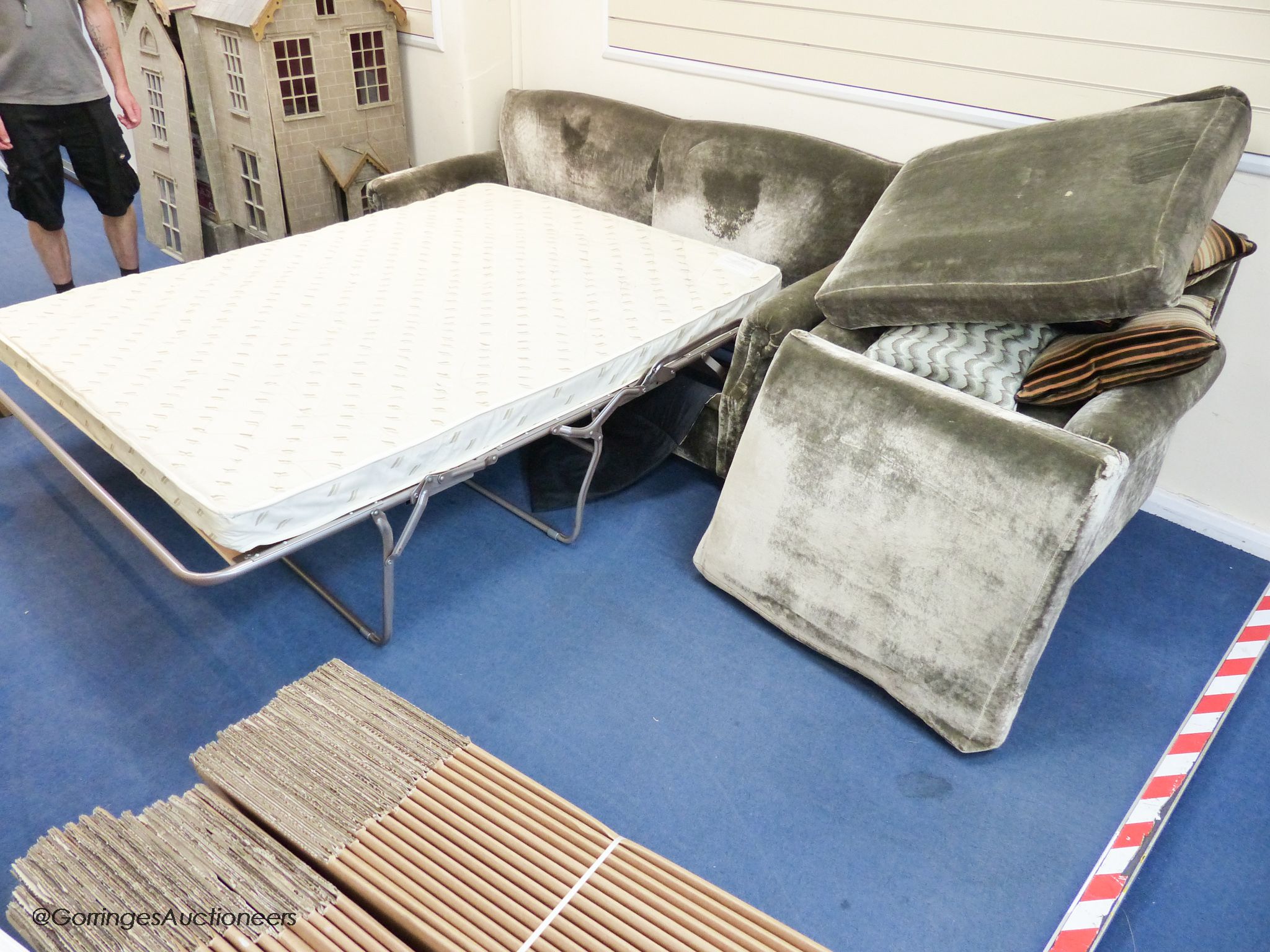 A grey velvet two seat sofa bed, approximately 191 cm wide and a matching armchair, various scatter cushions